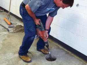 drilling a hole through concrete slab for foundation repair